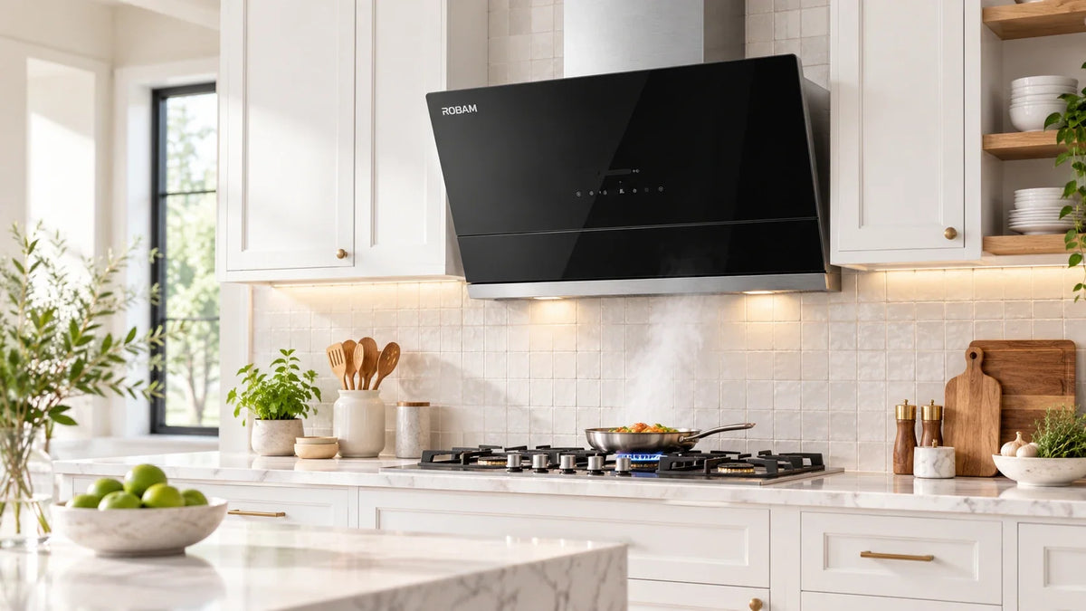 ROBAM gray slant-vent wall-mount range hood with touch controls and LED lighting, over a gas range in a modern marble kitchen