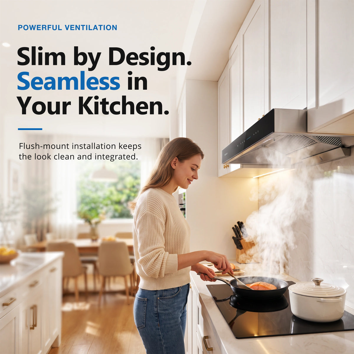 A woman cooks in a modern kitchen while a slim black range hood with a visible smoke detector above it releases steam. Text on the left reads, 'Slim by Design.